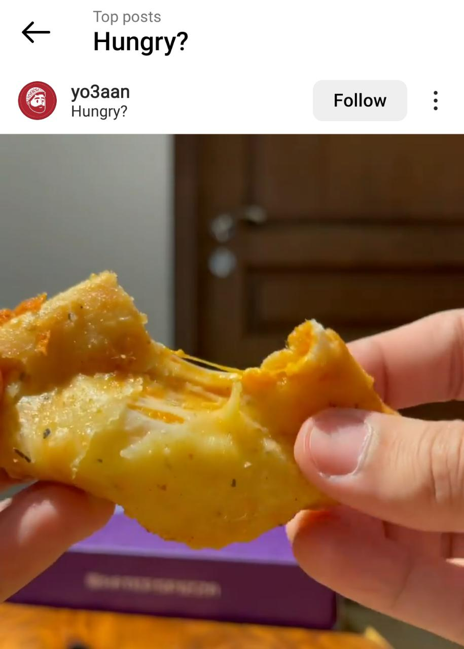 Instagram screenshot of an image of cheesy food with the geotag 'Hungry?'