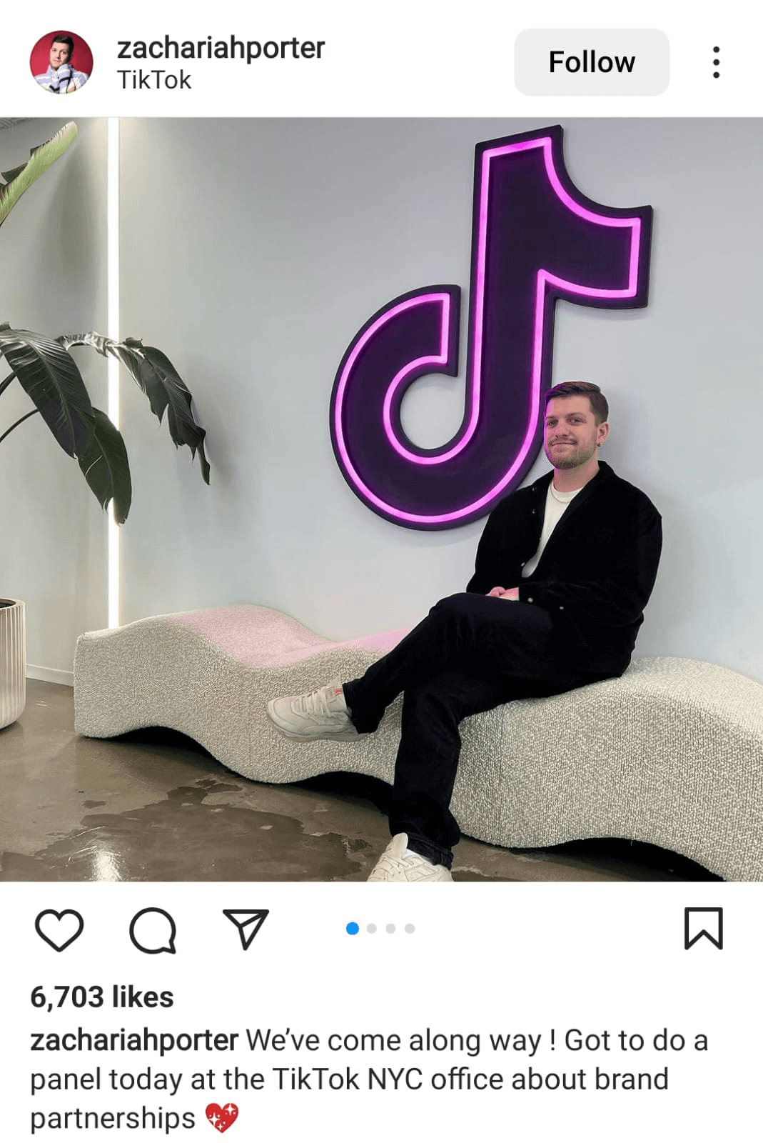 Instagram image of Zachariah Porter in an office with a large Tik Tok sign on the wall.