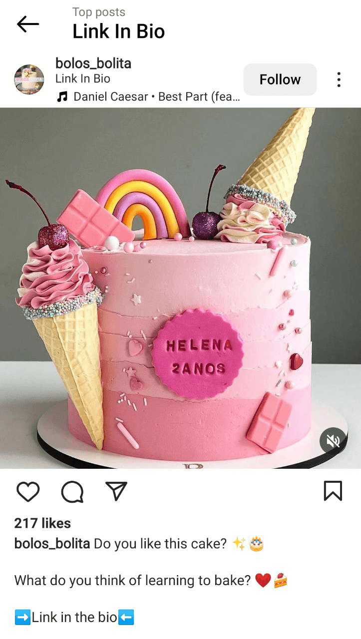 Instagram image of a cake with 'Link in the bio' in the caption and location tag.